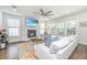 Cozy living room with fireplace, large windows, and comfortable white sofa with blue pillows at 312 Coki Amalie Ct, Charleston, SC 29492