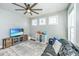 Comfortable living room with a black leather couch, ceiling fan, natural light, and television at 312 Coki Amalie Ct, Charleston, SC 29492