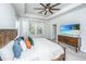 Bedroom with a wooden bed frame, a TV, ample windows, and a ceiling fan at 312 Coki Amalie Ct, Charleston, SC 29492