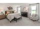 Serene primary bedroom with plush carpeting, decorative accents, and large windows for lots of natural light at 331 Calm Water Way, Summerville, SC 29486