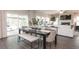 Open-concept living and dining area, filled with natural light, boasts hardwood floors and seamless access to the outdoor living space at 332 Calm Water Way, Summerville, SC 29486