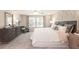 Serene main bedroom with soft carpet, a ceiling fan, and natural light, offering a tranquil retreat for rest and rejuvenation at 332 Calm Water Way, Summerville, SC 29486