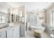Luxurious bathroom featuring a soaking tub, marble countertop vanity, and a glass enclosed shower at 34 Anson St, Charleston, SC 29401