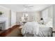 Spacious, well-lit bedroom with white decor, a decorative fireplace, and a cozy seating area with great natural light at 34 Anson St, Charleston, SC 29401