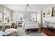 Bright bedroom featuring a fireplace, decor, and comfortable furnishings including a bed, chair, and bench at 34 Anson St, Charleston, SC 29401