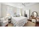 Cozy bedroom with a ceiling fan, plantation shutters, and a comfortable queen-size bed at 34 Anson St, Charleston, SC 29401