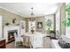 Charming dining room featuring a chandelier, fireplace, and views to the kitchen at 34 Anson St, Charleston, SC 29401