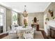 Beautiful dining area with chandelier, grasscloth wallpaper and views to a sitting area at 34 Anson St, Charleston, SC 29401