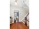 Inviting entryway with hardwood floors, staircase, and doorway to a bright living room filled with natural light at 34 Anson St, Charleston, SC 29401