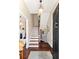 Foyer with stairs, hardwood floors, and a view of the powder room at 34 Anson St, Charleston, SC 29401