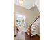 Inviting foyer with hardwood floors, staircase, and view into the bright, airy living room at 34 Anson St, Charleston, SC 29401