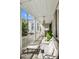 Covered front porch offers comfortable seating and neighborhood views, with elegant white columns at 34 Anson St, Charleston, SC 29401