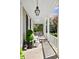 Inviting front porch with elegant white seating, decorative plants, and stylish outdoor lighting, ideal for relaxation at 34 Anson St, Charleston, SC 29401