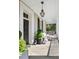 Charming front porch with outdoor seating, decorative planters, and a stylish lantern, perfect for relaxing outdoors at 34 Anson St, Charleston, SC 29401