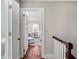 Hallway view of a well-lit bedroom featuring a seating area and bed, creating an inviting and serene space at 34 Anson St, Charleston, SC 29401