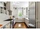 Well-lit kitchen with stainless steel appliances, white cabinets, and hardwood floors at 34 Anson St, Charleston, SC 29401