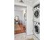 Laundry closet with stacked washer and dryer, and a view of the dressing table at 34 Anson St, Charleston, SC 29401