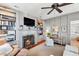 Bright and inviting living room with a fireplace, built-in bookshelves, desk and hardwood floors at 34 Anson St, Charleston, SC 29401