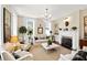 Elegant living room with a fireplace, chandelier, and ample seating offering a cozy and inviting atmosphere at 34 Anson St, Charleston, SC 29401