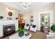 Elegant living room featuring a fireplace, chandelier, hardwood floors and stylish decor at 34 Anson St, Charleston, SC 29401