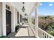 Inviting outdoor porch with white columns, black shutters, lantern lighting and outdoor seating at 34 Anson St, Charleston, SC 29401