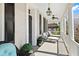 Outdoor porch seating area with white railings, black shutters, lighting and ceiling fans at 34 Anson St, Charleston, SC 29401