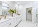 Bathroom featuring dual sink vanity, decorative mirrors, and marble tiled shower at 356 Claret Cup Way, Charleston, SC 29414