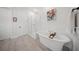 Bright bathroom featuring a modern tub, glass enclosed shower, and contemporary artwork at 3785 Summerton St, Mount Pleasant, SC 29466