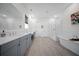 Spacious bathroom featuring a soaking tub, glass shower, and double vanity with neutral gray cabinets at 3785 Summerton St, Mount Pleasant, SC 29466
