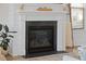 Close up of fireplace with white trim, black surround, and wood logs at 3785 Summerton St, Mount Pleasant, SC 29466