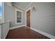 Charming front porch featuring wood flooring, a cozy light fixture, and a classic wood door at 3785 Summerton St, Mount Pleasant, SC 29466