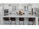 Bright kitchen with white cabinets, a large island with barstool seating and modern lighting at 3785 Summerton St, Mount Pleasant, SC 29466