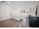 Bedroom with wood floors, windows, and minimalist decor, neutral tones at 3785 Summerton St, Mount Pleasant, SC 29466