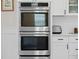 Stainless steel double ovens built into the white cabinets in this modern kitchen at 3785 Summerton St, Mount Pleasant, SC 29466