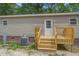 Exterior shot of back porch with wood-look stairs and wood railings at 413 Peacock Ln, Summerville, SC 29486