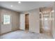 Bright bedroom featuring light wood-look floors, neutral walls, a closet, and an exterior door at 413 Peacock Ln, Summerville, SC 29486