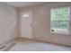 Bright entryway featuring neutral walls, new carpet, and a window near the front door, creating a welcoming atmosphere at 413 Peacock Ln, Summerville, SC 29486