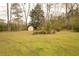 Spacious backyard with mature trees, a shed and grassy areas great for outdoor activities at 424 Salley Ackerman Dr, Cottageville, SC 29435