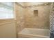 Bathtub and shower are tiled with a neutral pattern in this bathroom at 424 Salley Ackerman Dr, Cottageville, SC 29435