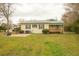 Exterior view of a single story house with a green metal roof and a lush lawn at 424 Salley Ackerman Dr, Cottageville, SC 29435