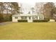 Charming one-story home featuring a manicured lawn and a green metal roof at 424 Salley Ackerman Dr, Cottageville, SC 29435