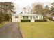 Inviting single-story house with well-kept lawn, driveway, and complementary green trim at 424 Salley Ackerman Dr, Cottageville, SC 29435