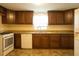 Traditional kitchen features wood cabinets, granite countertops, and white appliances at 424 Salley Ackerman Dr, Cottageville, SC 29435