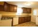 Efficient kitchen with granite countertops, stainless steel sink, and brown cabinetry at 424 Salley Ackerman Dr, Cottageville, SC 29435