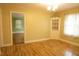 Bright living room featuring hardwood floors, a vintage corner cabinet, and neutral walls at 424 Salley Ackerman Dr, Cottageville, SC 29435