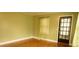 Bright living room with natural wood floors, soft green walls, and charming window at 424 Salley Ackerman Dr, Cottageville, SC 29435