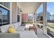 Relaxing screened-in porch features comfortable seating, string lights, and a view of the neighborhood at 4603 Scout Aly, North Charleston, SC 29405