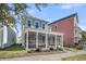 Charming two-story home featuring a spacious screened-in back porch with manicured landscaping at 4603 Scout Aly, North Charleston, SC 29405