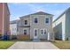 Back of home with a small yard, a shed, and a light-colored exterior at 4603 Scout Aly, North Charleston, SC 29405