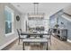 Bright dining room with modern lighting, wood table with seating for six, and light wood flooring at 4603 Scout Aly, North Charleston, SC 29405